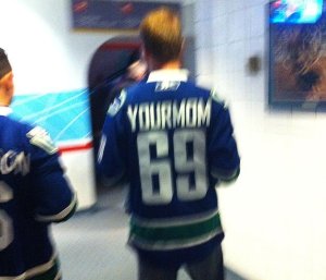 Aptly enough, a Canucks fan serves as our model for the "stupid hockey douche" archetype.  Note the name bar and # choice.